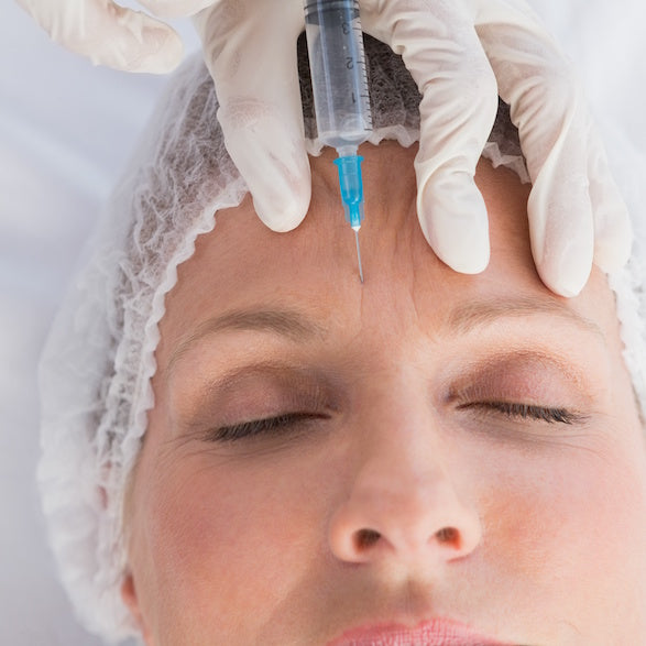 A woman getting either a Botox or filler cosmetic injection