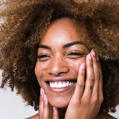 A woman who looks like her skin has been freshly exfoliated with AHAs or BHAs