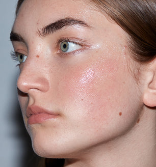 A woman using SLMD by Dr. Sandra Lee Hyaluronic Acid Serum for hydrating and moisturizing