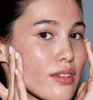 A woman applying SLMD Bright Future Vitamin C Serum by Dr. Sandra Lee