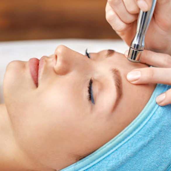 A woman getting the exfoliating and resurfacing treatment microdermabrasion