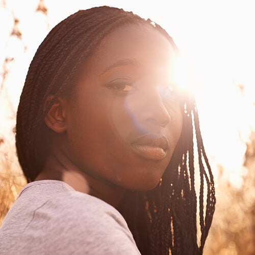 A woman with clear skin with sunlight on her face