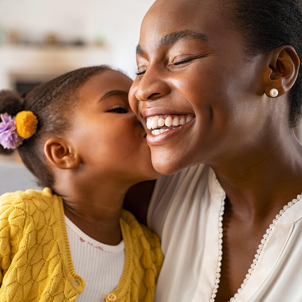 A young girl and her busy mom with glowing skin