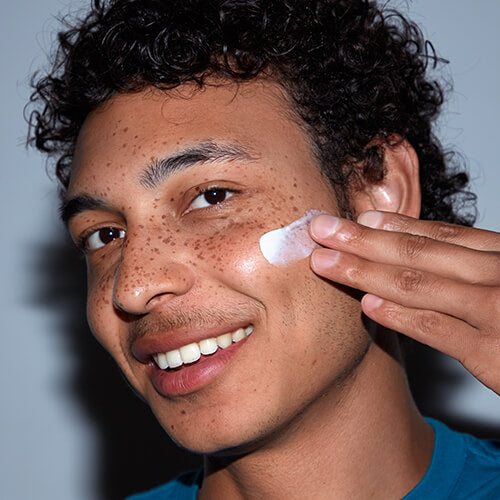 A man with oily skin layering on skincare