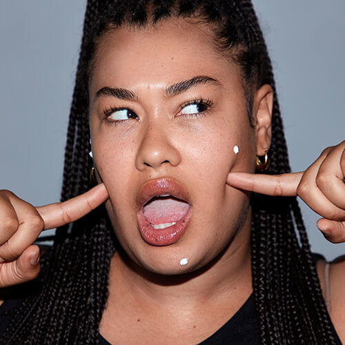 Photo of a woman with acne spot treatment on pimples